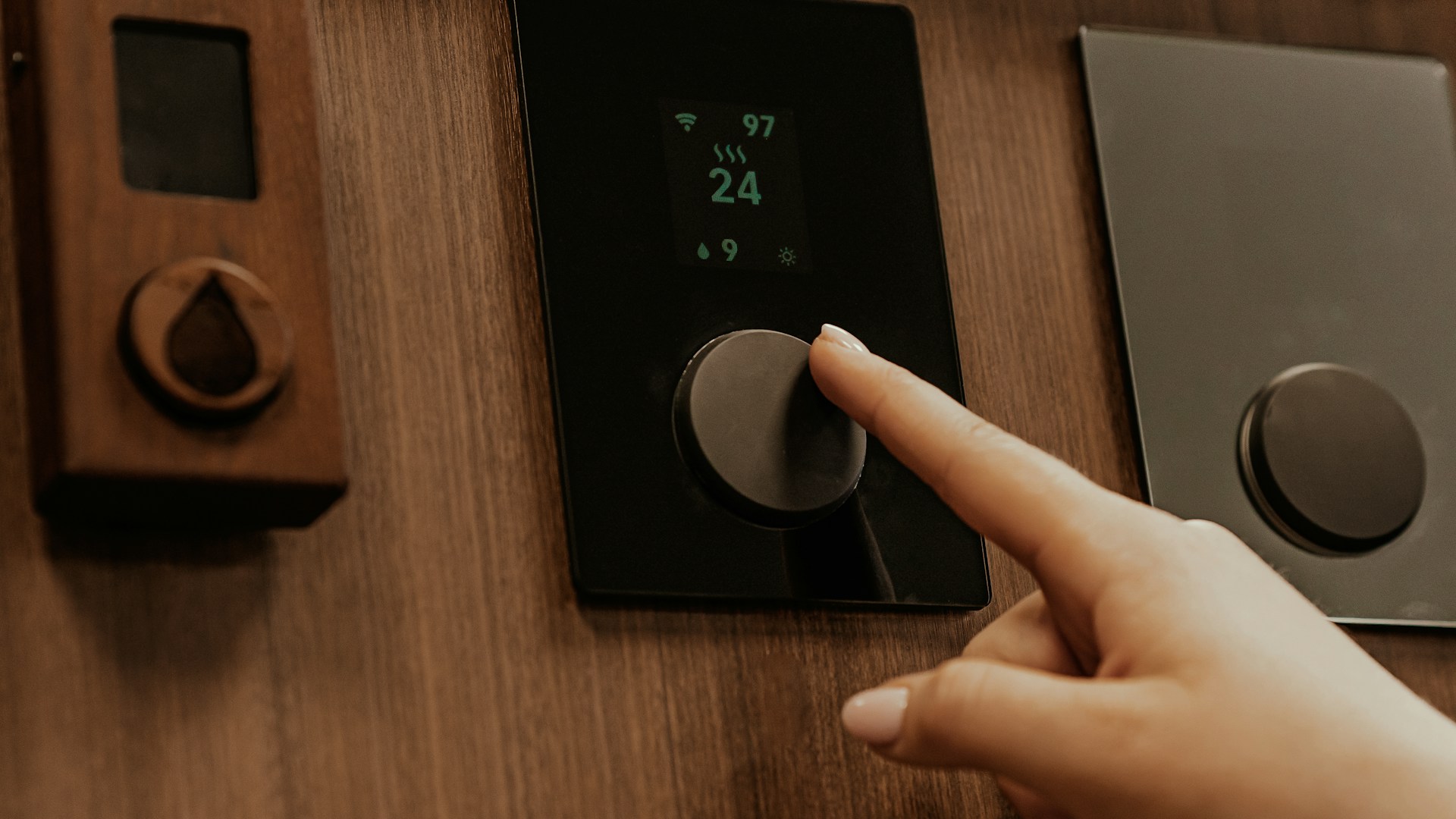 a hand holding a black device