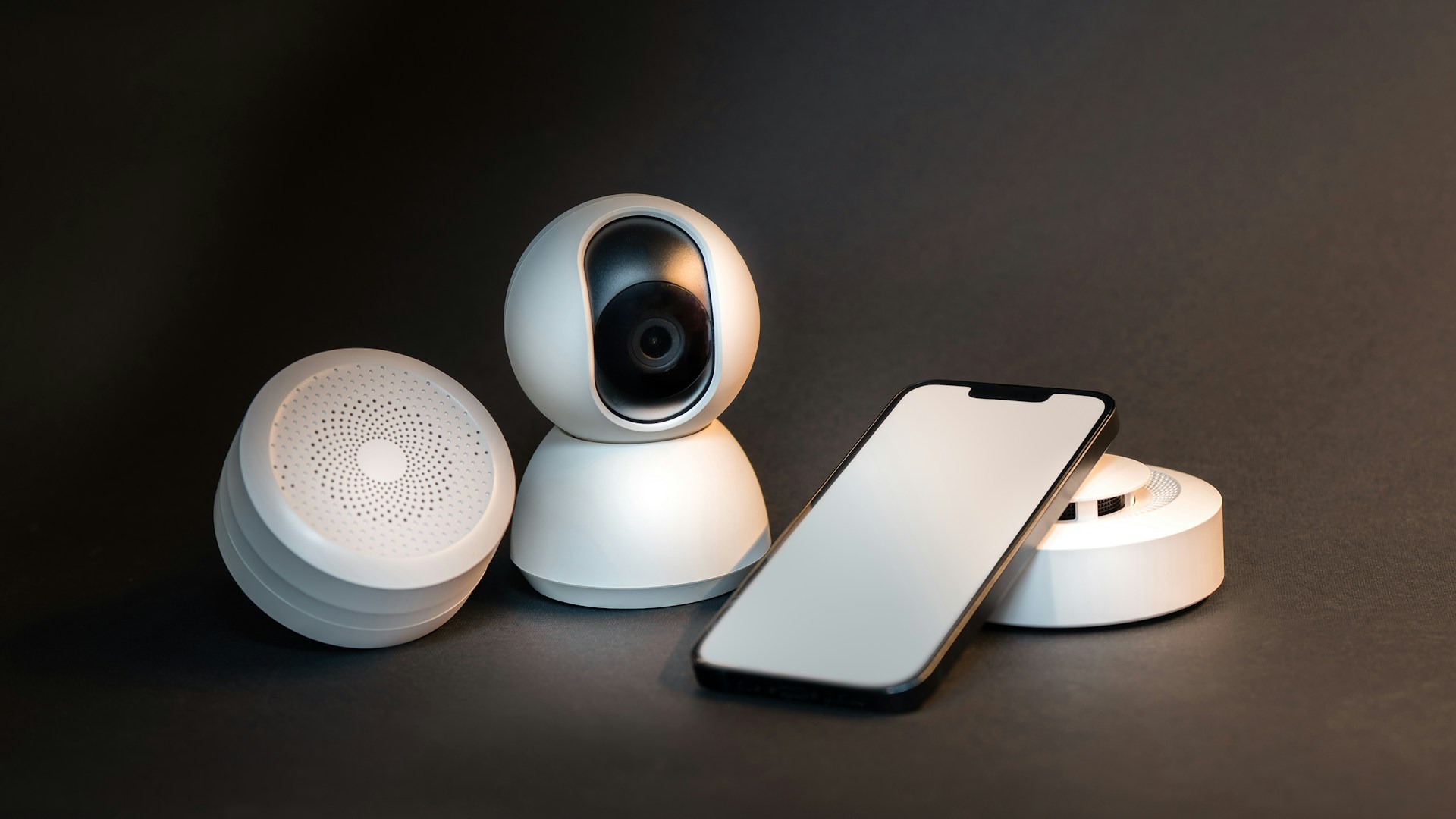 a smart phone sitting next to a wireless security camera