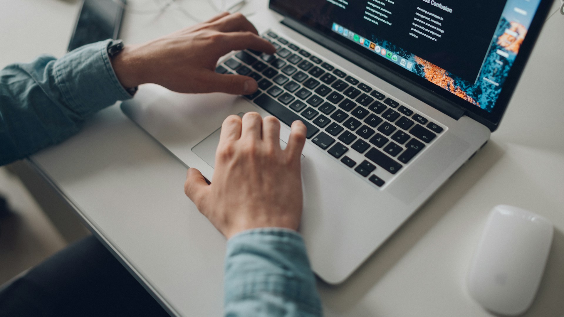 person wearing long-sleeve top working on laptop