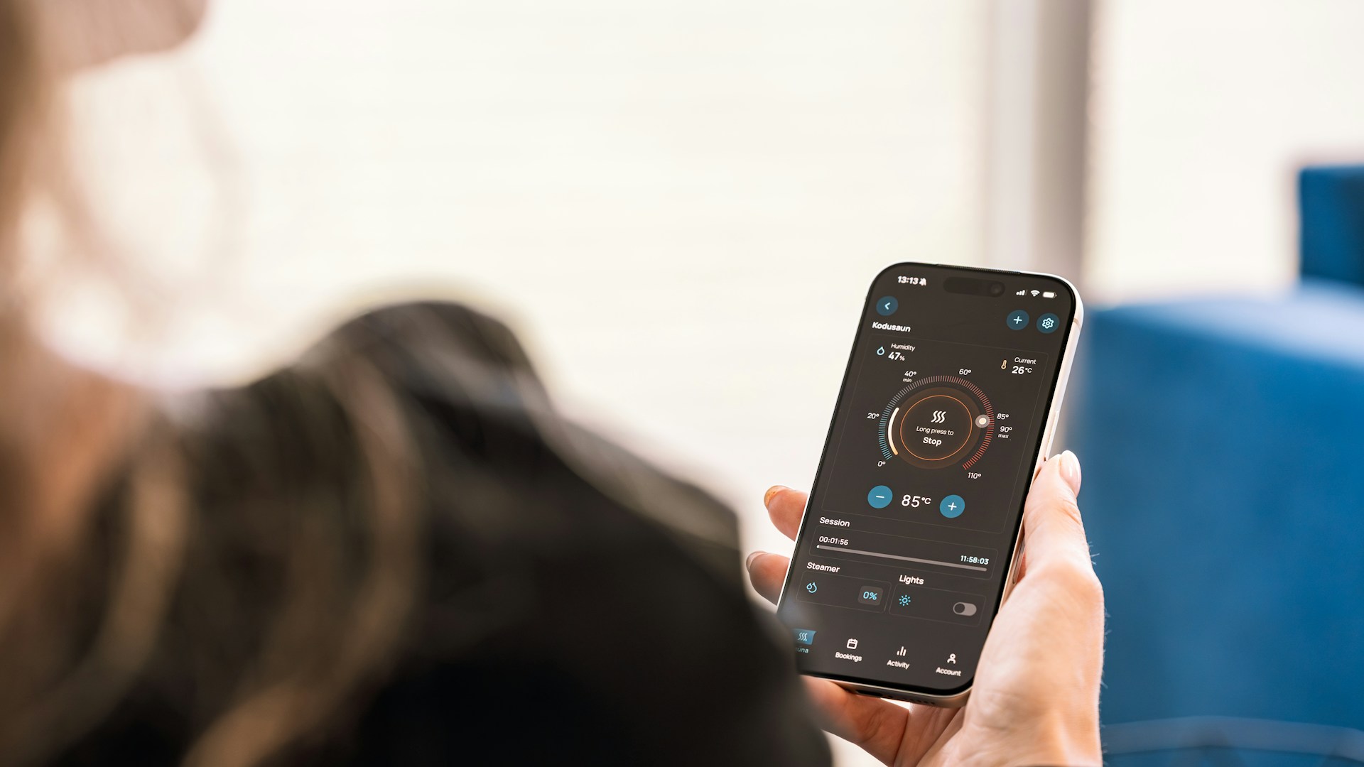 Person holding a smartphone displaying an application.