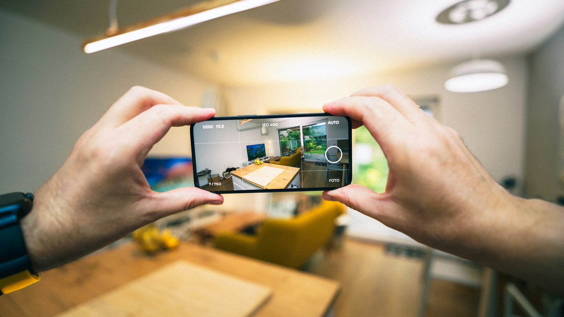 A person taking a picture with a cell phone